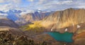 Mountain landscape, Altai. Lake in a deep gorge, colored rocks, morning light.