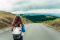 Girl with a backpack stands with her back