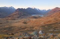 Mountain landscape on the background of a lake and blue sky. Dawn in autumn. Altai, Russia.