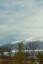 Mountain landscape background. snowy hills and forest. power lines in mountains