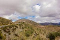 Mountain landscape on blue cloudy sky background. Picturesque landscape of the mountains glowing under sunlight.