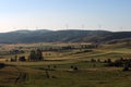 Mountains landscape with a blue cloudy sky, windmills