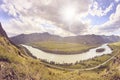 Mountain landscape. Blue sky. White clouds. Green trees. River Royalty Free Stock Photo