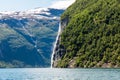 Mountain landscape with cloudy sky. Beautiful nature Norway. Geiranger fjord. Seven Sisters Waterfall Royalty Free Stock Photo