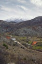 Mountain landscape with country road and small village on cloudy day. Balkans, Montenegro Royalty Free Stock Photo