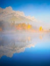 Mountain landscape at dawn. Foggy morning. Lake and forest in a mountain valley at dawn. Royalty Free Stock Photo