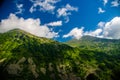 Mountain landscape. deciduous forest. cloud on top. morning light