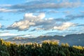 Mountain landscape with fertile valley below steep forests and ancient agricultural terraces at sunset Royalty Free Stock Photo