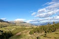 Mountain landscape with fertile valley below steep forests and ancient agricultural terraces at sunset