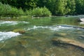 Mountain landscape, forest and fast mountain river. Beautiful scenery with a mountain river Royalty Free Stock Photo