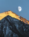 Mountain landscape with an almost full moon and sunset with Soviet Peak and Skalisty Peak in Big Almaty Gorge in Kazakhstan, Royalty Free Stock Photo