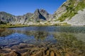 Mountain landscape and glacial Taul Portii lake in Retezat National Park, Carpathian Mountains, Romania, at sunrise Royalty Free Stock Photo