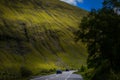 Mountain landscape in the Glencoe area in Scotland, Springtime view mountains with grassland and countryside road in the valley of Royalty Free Stock Photo