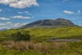 Mountain landscape in the Glencoe area in Scotland, Springtime view mountains with grassland and countryside road in the valley of Royalty Free Stock Photo