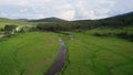 Mountain landscape with green fields intersected by a clear stream