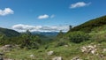 Mountain landscape. On the hillsides, among the green grass and trees, stones are scattered Royalty Free Stock Photo