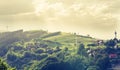 Mountain landscape - Houses and windmills on the mountain - spring green and sunrays - ecological landscape.