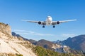 Mountain landscape and landing passenger aircraft. Travel to the mountainous countries