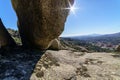 Mountain landscape with large granite rocks, blue sky and sun on the horizon with sun flare and desert atmosphere. Valdemanco,