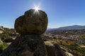 Mountain landscape with large granite rocks, blue sky and sun on the horizon with sun flare and desert atmosphere. Valdemanco,