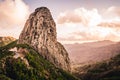 Mountain landscape with large rock formation. Roque de Agando. Hiking trail with sunset view of La Gomera, Canary Islands