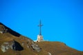 Mountain landscape with metallic cross and a blue sky