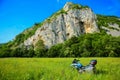 Motorcycle in a meadow at the foothill of the mountain - mountain landscape - BMW F650 GS