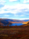 Mountain landscape in Northern Norway. Autumn colors, mountain lake, turquoise cloudy sky. Royalty Free Stock Photo