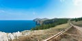 Mountain landscape of Olkhon island. Blue sky over the Maloye More Strait and cape Khoboi. View from cape Sagan Khushum. Panorama Royalty Free Stock Photo