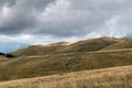 Mountain landscape with pastures and sun spots on top