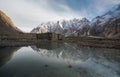 Mountain landscape with reflection on the water. Stone hut stand alone at Karakoram range in Pakistan