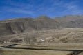 Mountain landscape with a river that goes to the arid valley during daylight