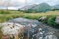 Mountain landscape. Mountain river, grass and mountains.Water flow. Beautiful landscape. Royalty Free Stock Photo