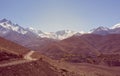 Mountain landscape with road running through wasteland. Royalty Free Stock Photo