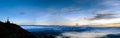 Mountain landscape with the silhouettes of hikers, the top of a mountain and the cross of the Matagalls del Montseny peak in the