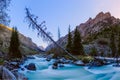 Mountain landscape. Snow-covered mountain peaks. Mountain creek bluish color, shot on a long exposure.