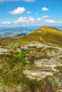 Mountain landscape with stones in the grass on hillside and blue Royalty Free Stock Photo