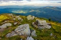 Mountain landscape with stones in the grass on hillside and blue Royalty Free Stock Photo