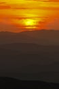 Mountain landscape at sunset. Amazing view from the mountain peak on rocks, low clouds, blue sky and sea in the evening. Colorful Royalty Free Stock Photo