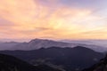 Mountain landscape at sunset in Julian Alps. Amazing view on colorful clouds and layered mountains silhouettes. Royalty Free Stock Photo