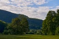 Mountain Landscape At Sunset. Scenery With Stones On The Hillside. Distant Valley Between Forested Hills In Evening Royalty Free Stock Photo