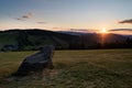 Mountain landscape at sunset. Stone in the foreground on the field