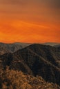 Mountain landscape at sunset. View of big mountains at sunset with bright orange sky Royalty Free Stock Photo