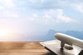 Mountain landscape with a view of the forest and white model of passenger plane on old wooden background.