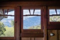 Mountain landscape visible through wooden framed windows; focus on the background, California