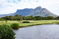 Mountain, landscape and water with grass at golf course in summer on holiday or vacation. Calm, morning and lake with Royalty Free Stock Photo