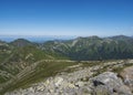 Mountain landscape of Western Tatra mountains with woman with bacpack and dog on hiking trail on Baranec. Sharp green Royalty Free Stock Photo