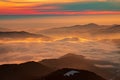 Mountain landscape with winter fog at sunse of Ceahlau, Romaniat Royalty Free Stock Photo