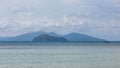 Mountain with local fisherman boat floating over the sea with bright sky in background in the afternoon at Koh Mak Island in Trat Royalty Free Stock Photo