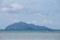 Mountain with Local Fisherman Boats on the right side floating over the sea with bright sky in background in the afternoon. Royalty Free Stock Photo